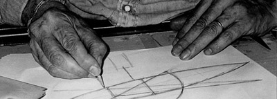 Joan Pedragosa drawing a sketch on his work table.